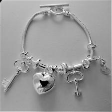 Sterling silver snake charm bracelet. Heart and keys. T-bar closure.