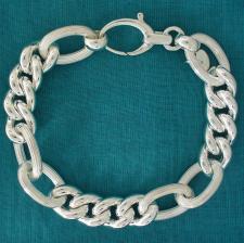 Sterling silver textured oval link bracelet. Curb link 12mm. Hollow link.