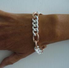 Sterling silver bracelet with 18 kt rose gold plating. Textured oval link bracelet. Curb link 12m...