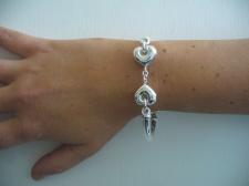 Sterling silver bangle bracelet with hearts.