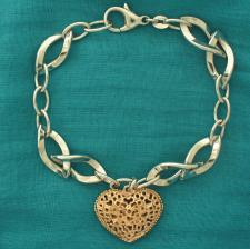Sterling silver bracelet with 18 kt rose gold plating heart charm.