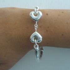 Sterling silver bangle bracelet with hearts.