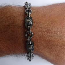 Silver bracelet with screws.