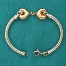 Sterling silver semi-bangle bracelet with 18 kt rose gold plating double hearts.