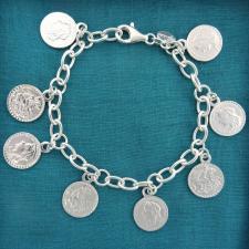 Coin charm bracelet in sterling silver.