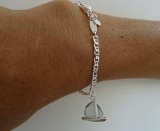 Silver bracelet with sailboat charm