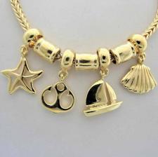 Sterling silver with 18 kt yellow gold plating. Ocean life charm bracelet.